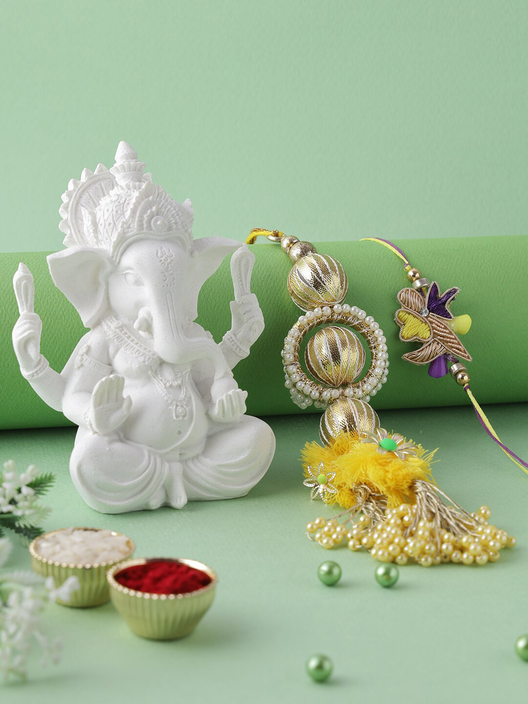 

Aapno Rajasthan Gold and Lavender Polyresin Ganesha Idol with Bhaiya Bhabhi Rakhi Gift Set