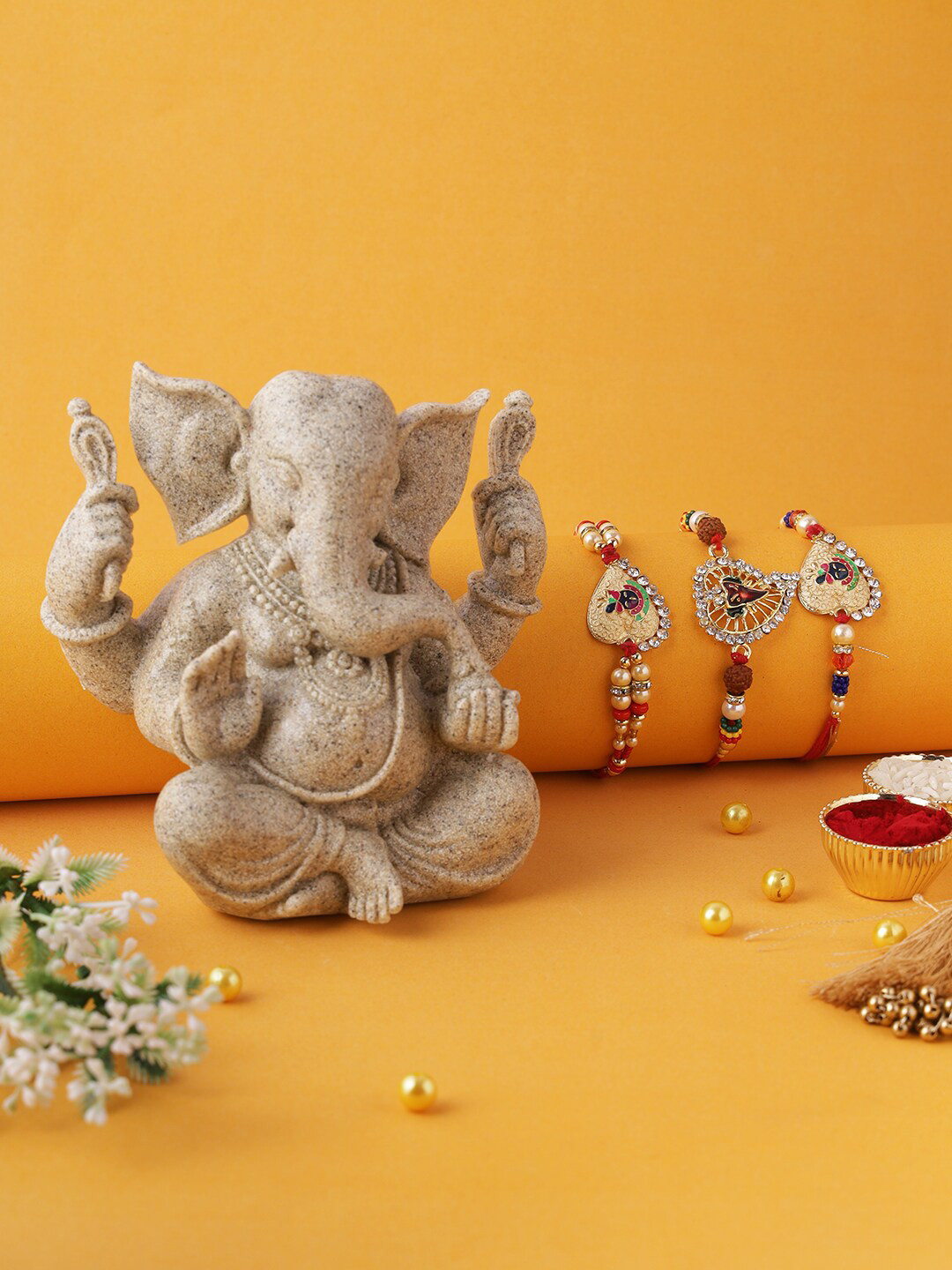 

Aapno Rajasthan Gold and Red Set of 3 Rakhi with Beautiful and Pristine Sand Stone Idol