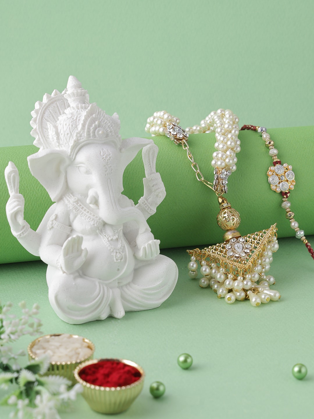 

Aapno Rajasthan Polyresin Ganesha Idol With Bhaiya Bhabhi Rakhi Gift Set, Multi