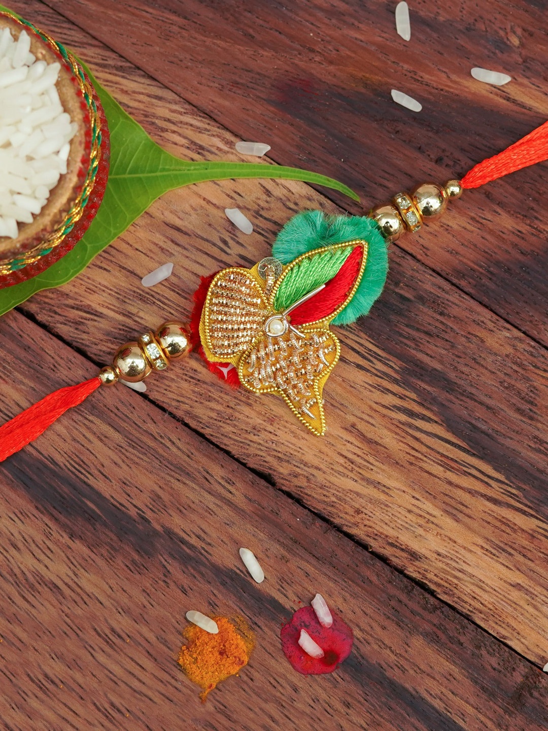 

The Magic Wand Gold Coloured & Red Beaded Thread Rakhi