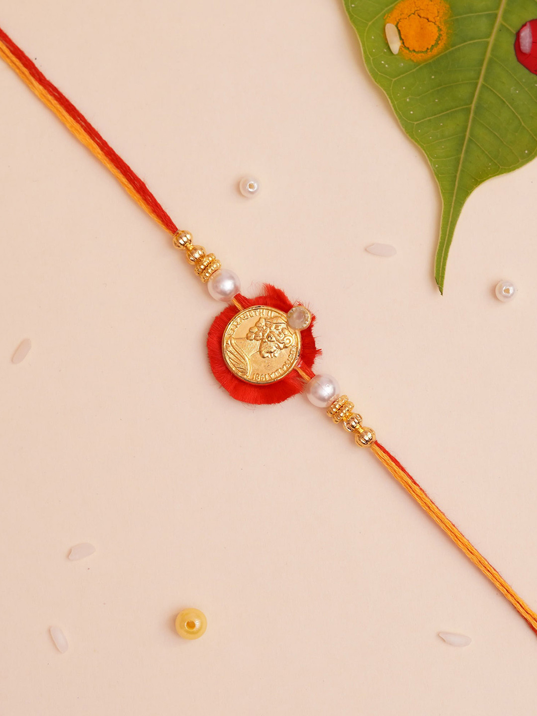 

The Magic Wand Gold Coloured & Red Beaded Thread Rakhi