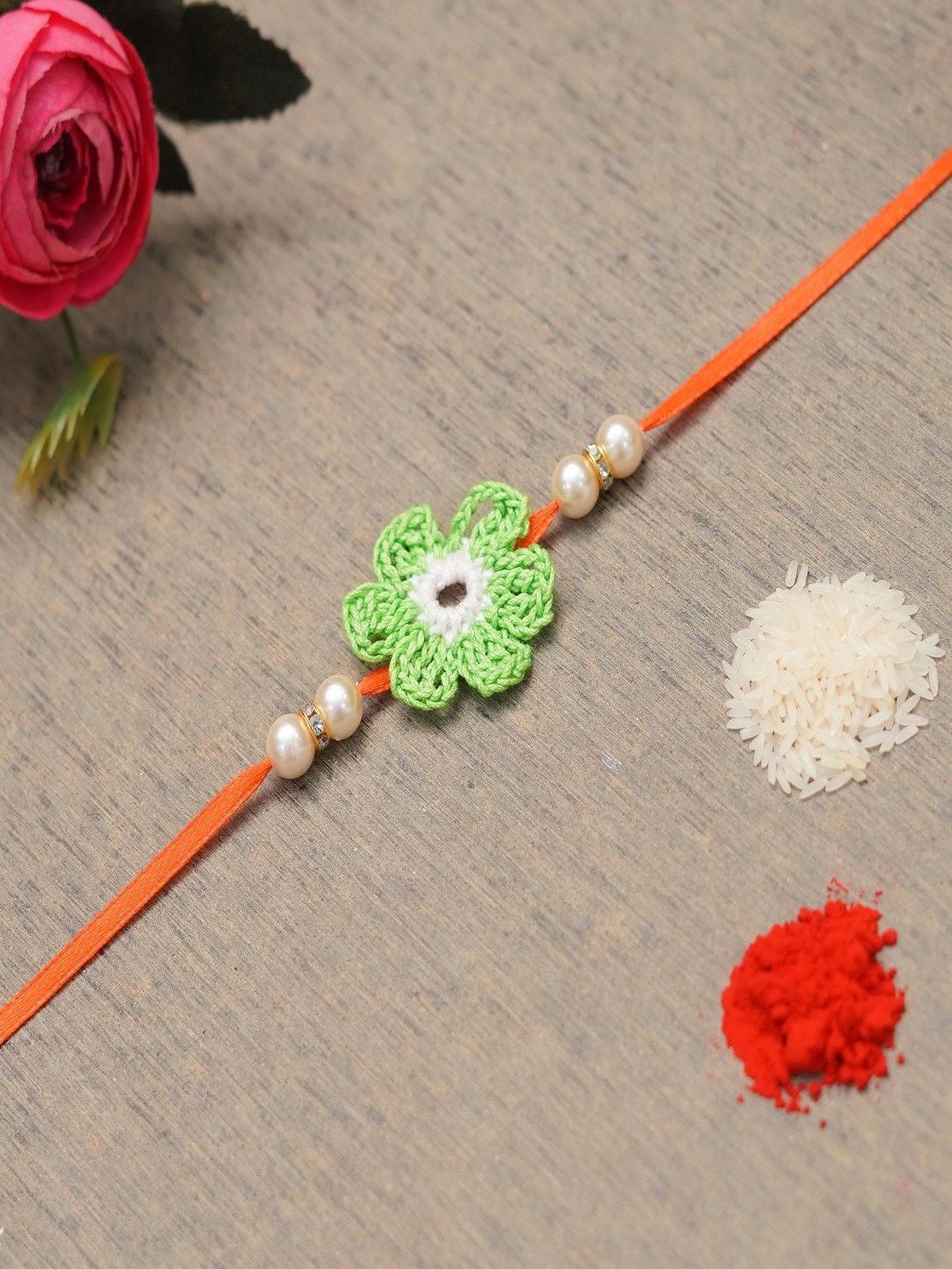 

The Magic Wand Green & Orange Coloured Floral Beaded Thead Rakhi