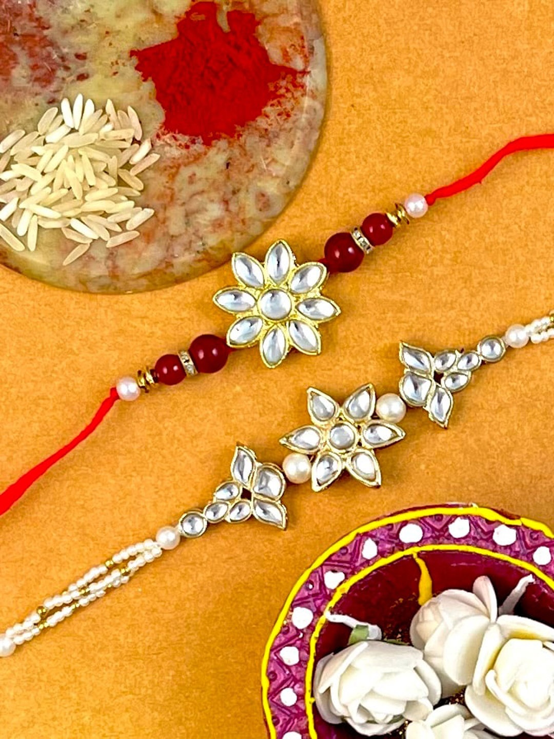 

KARATCART Set of 2 Gold-Plated Kundan-Studs & Beaded Rakhi With Roli & Chawal