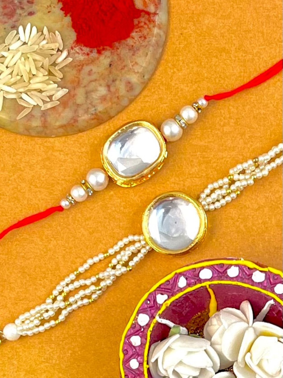 

KARATCART Set Of 2 Gold-Toned & White Stone-Studded & Beaded Rakhi With Roli & Chawal