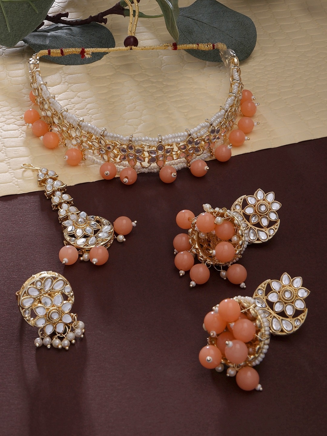 

Zaveri Pearls Gold-Plated Gold-Toned Peach Toned Kundan Studded Jewellery Set