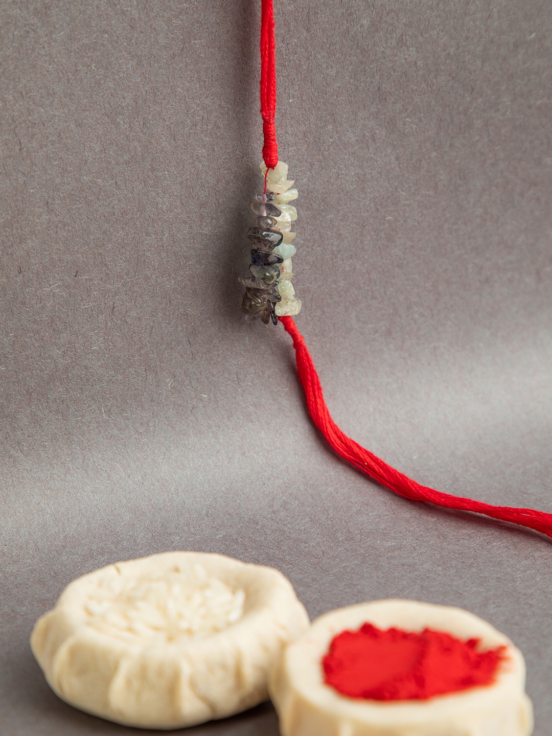 

DEEBACO Purple & Red lolite & Aquamarine Healing Stone Rakhi With Roli-Chawal