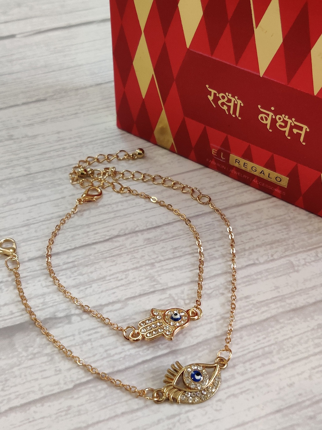 

EL REGALO Set of 2 Evil Eye Wrap Around Rakhi With Roli Chawal & Greeting Card, Gold
