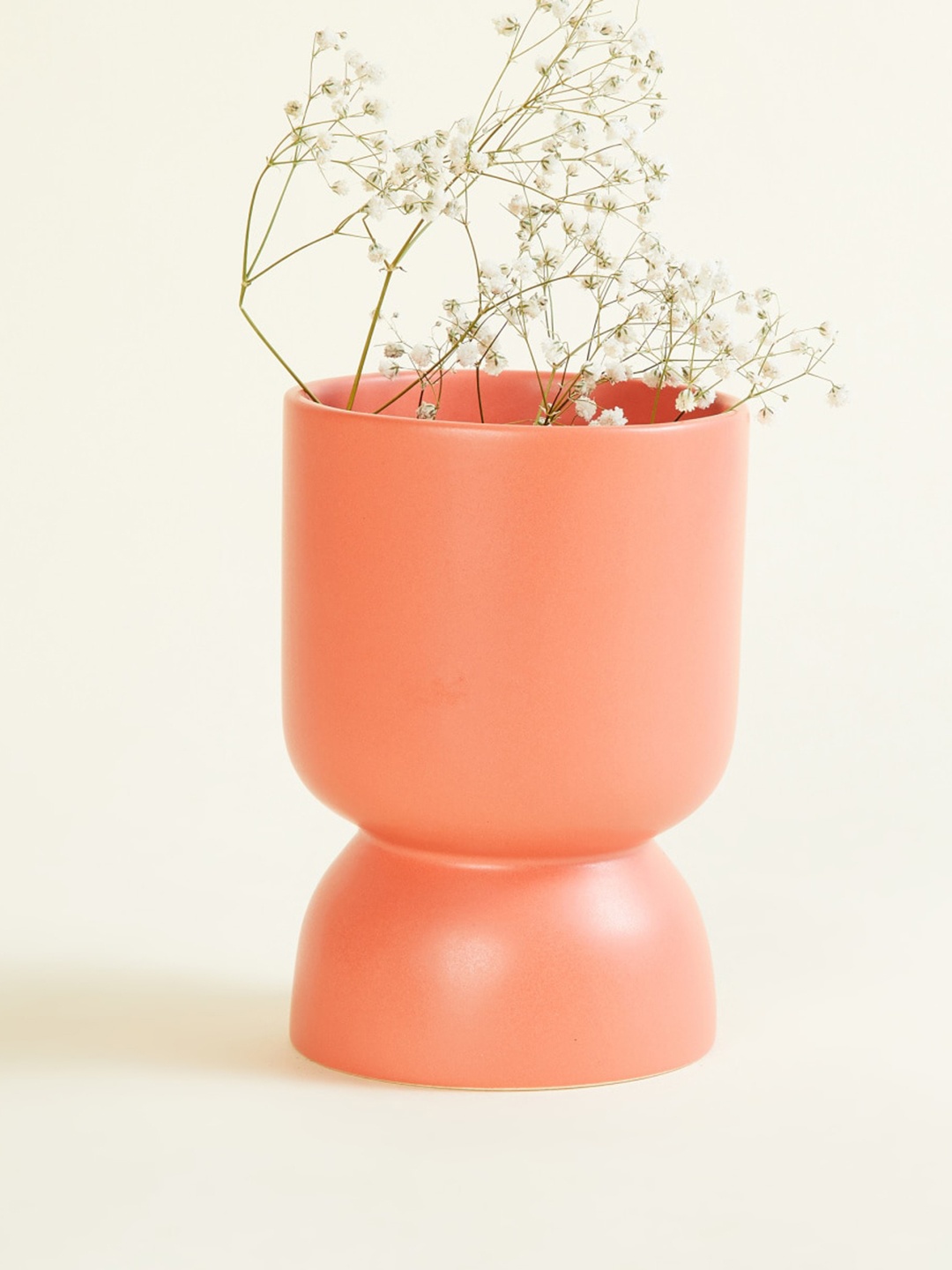

Home Centre Splendid Peach-Colored Solid Ceramic Abstract Vase