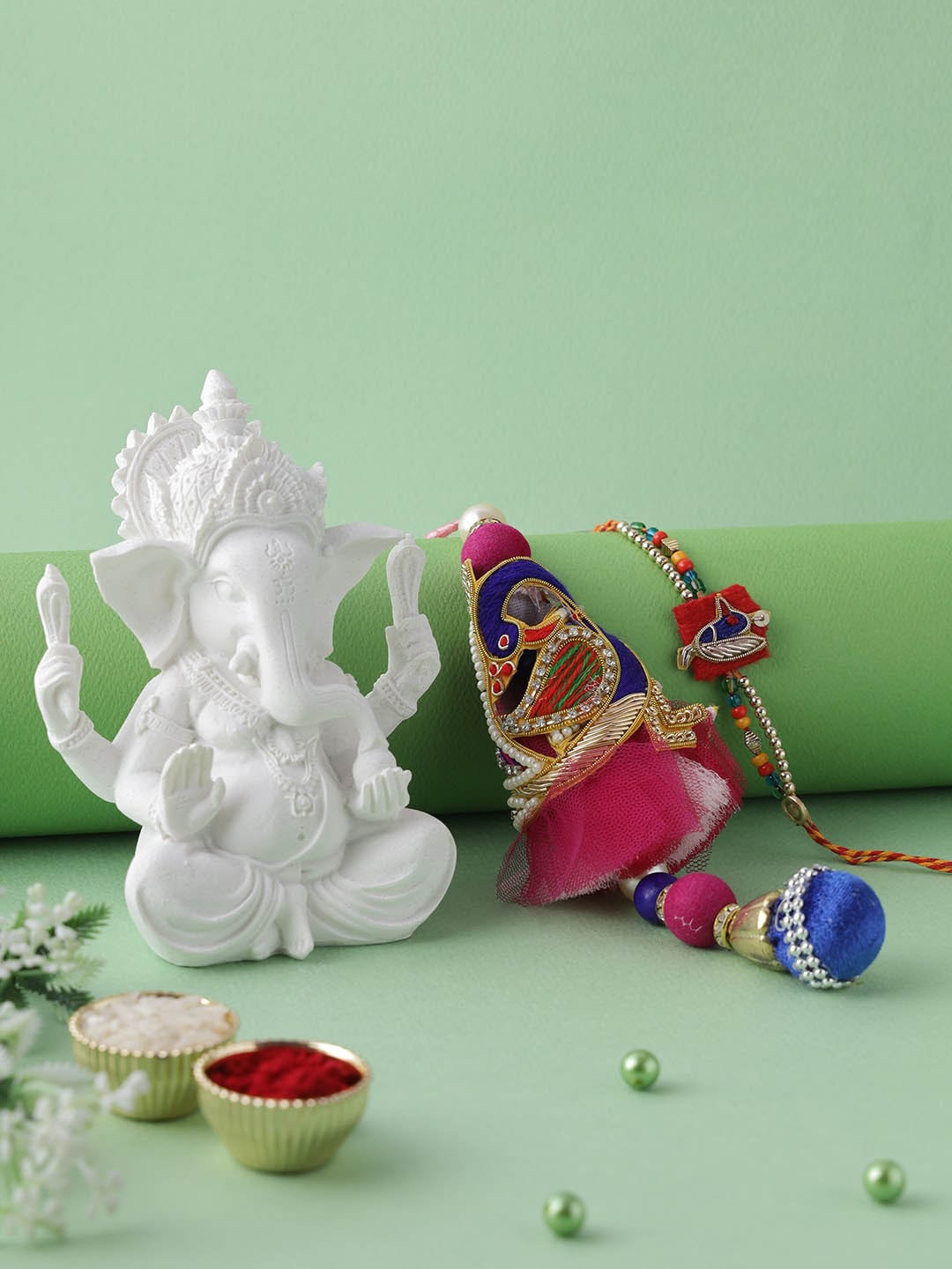 

Aapno Rajasthan Red Ganesha Idol Rakhi Gift Set