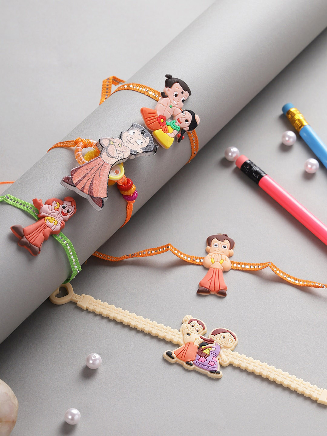 

Aapno Rajasthan Set Of 5 Red & Beige Chota Bheem-Charm Rakhi With Roli Rice & Rakhi Card