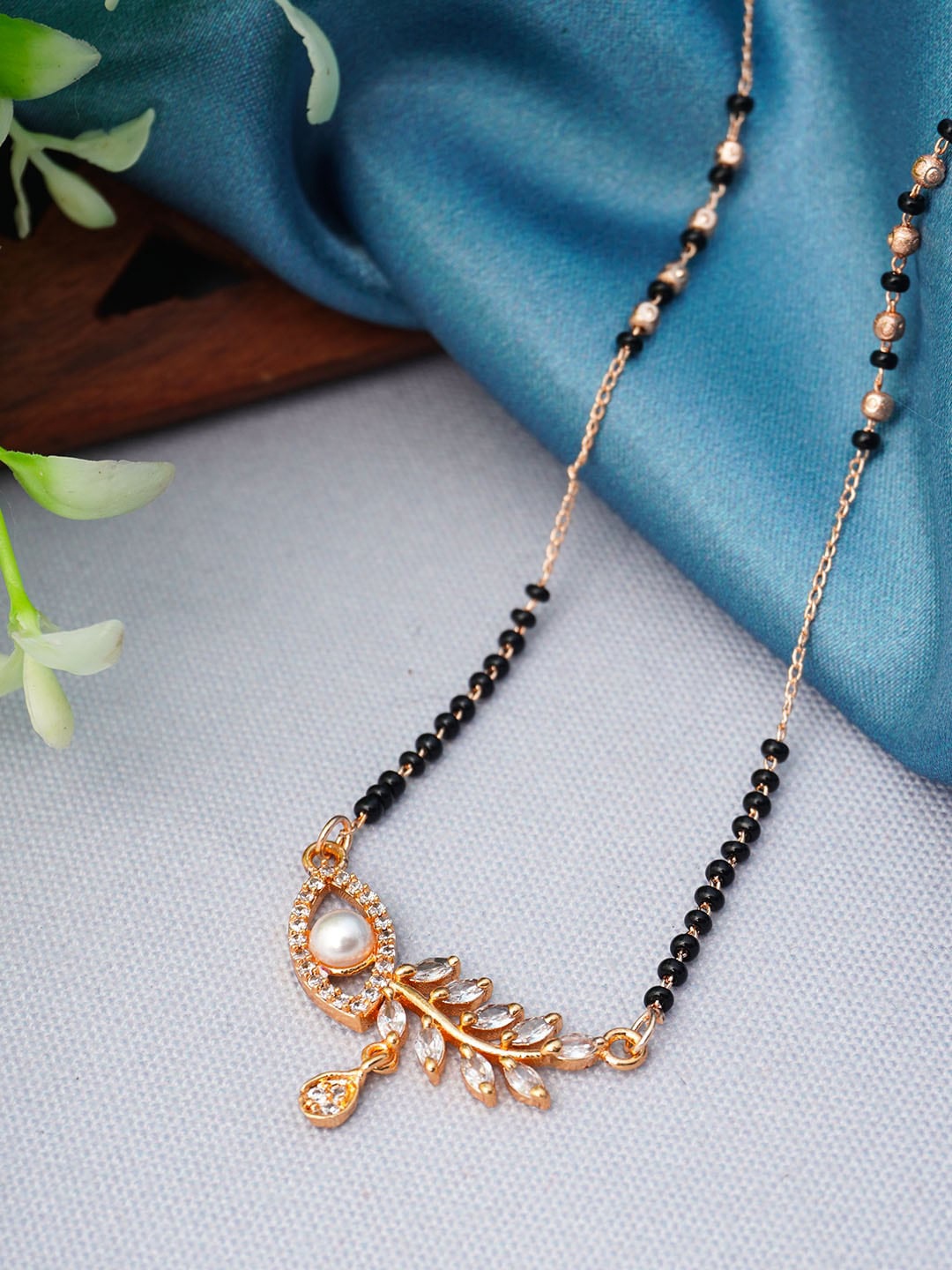 

Urmika Rose Gold-Plated Black Beaded White AD-Studded Mangalsutra