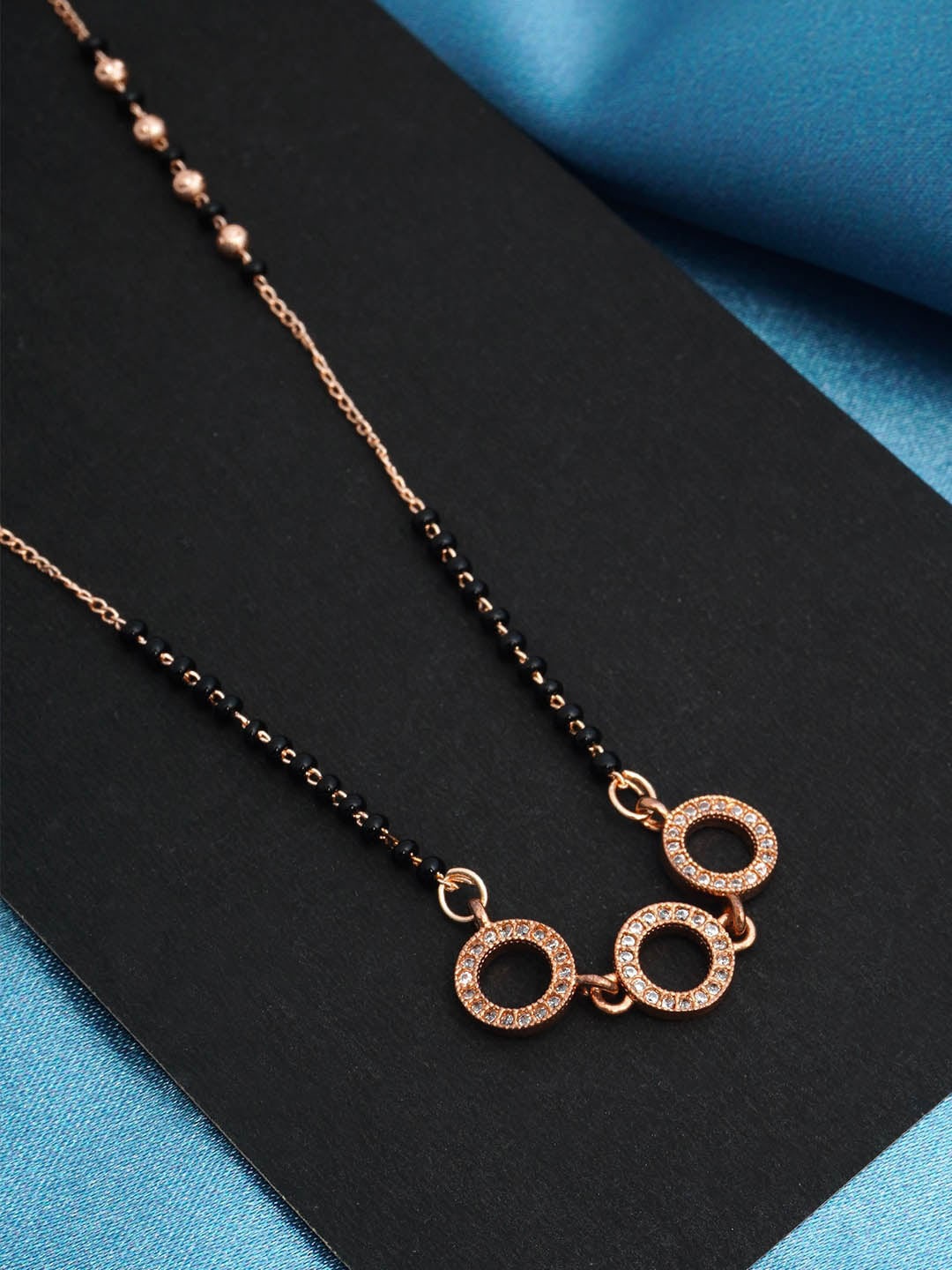 

Urmika Rose Gold Plated Black Beaded White AD Studded Mangalsutra