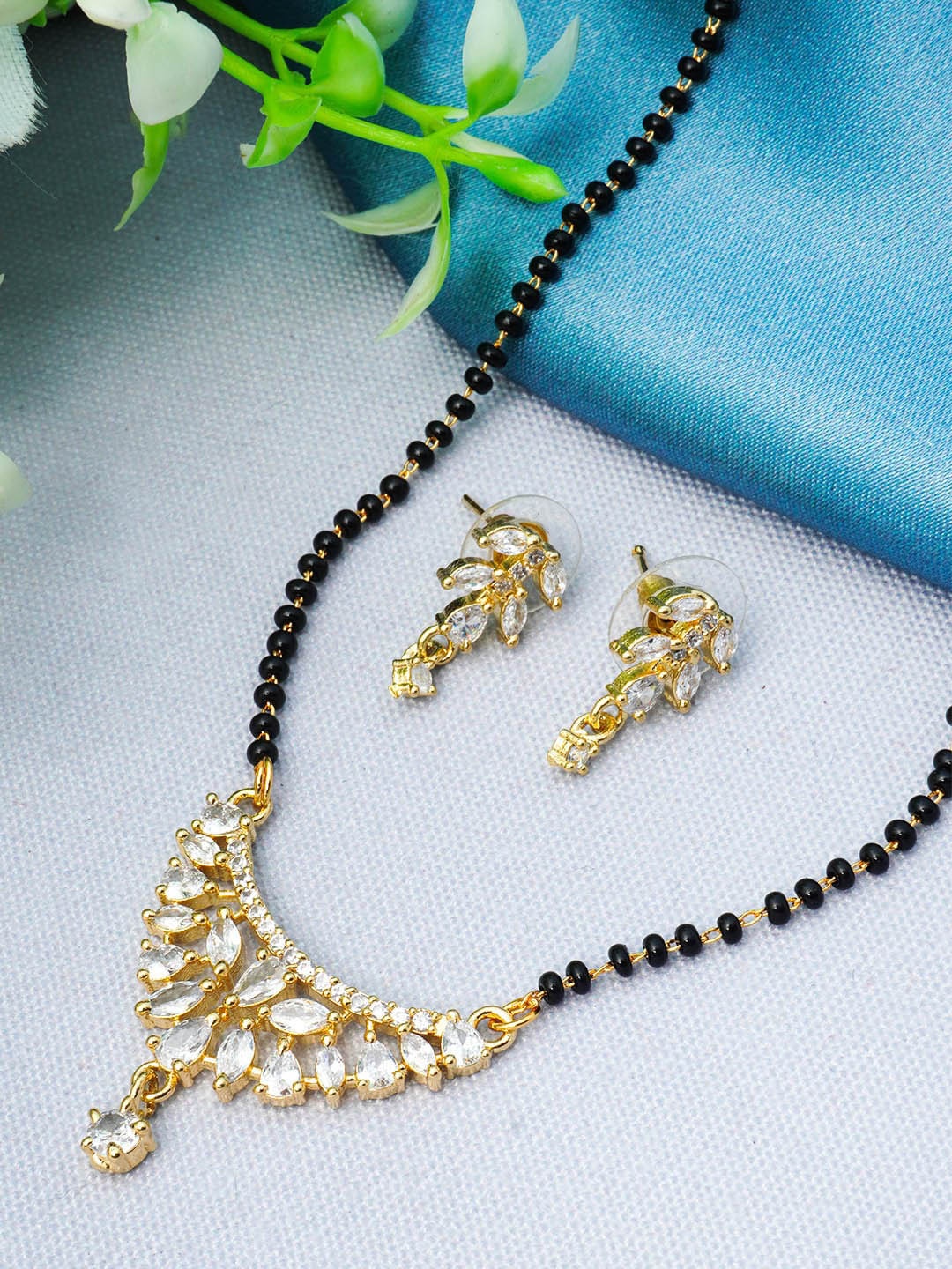 

Urmika Gold-Plated AD-Studded and Beaded Mangalsutra With Earring Set