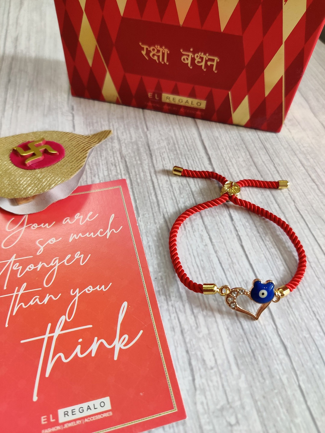 

EL REGALO Gold Coloured & Red Wrap Around Rakhi With Roli Chawal & Raksha Bandhan Greeting Card