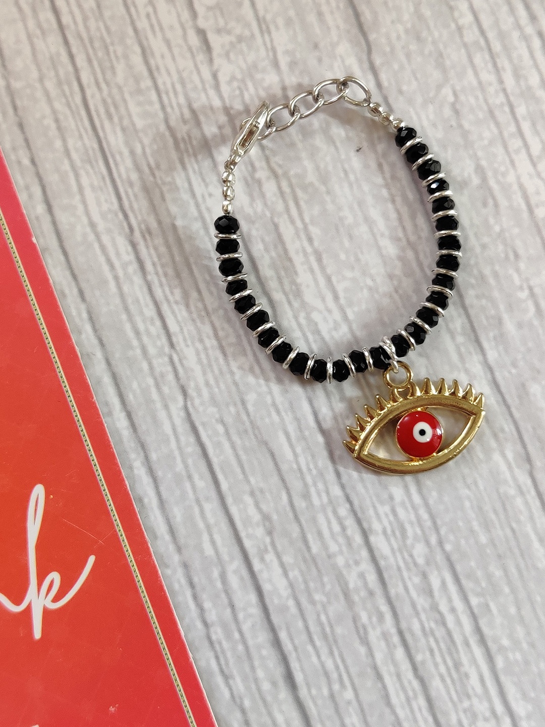 

EL REGALO Gold Coloured Black Evil Eye Rakhi for Baby With Roli Chawal Greeting Card