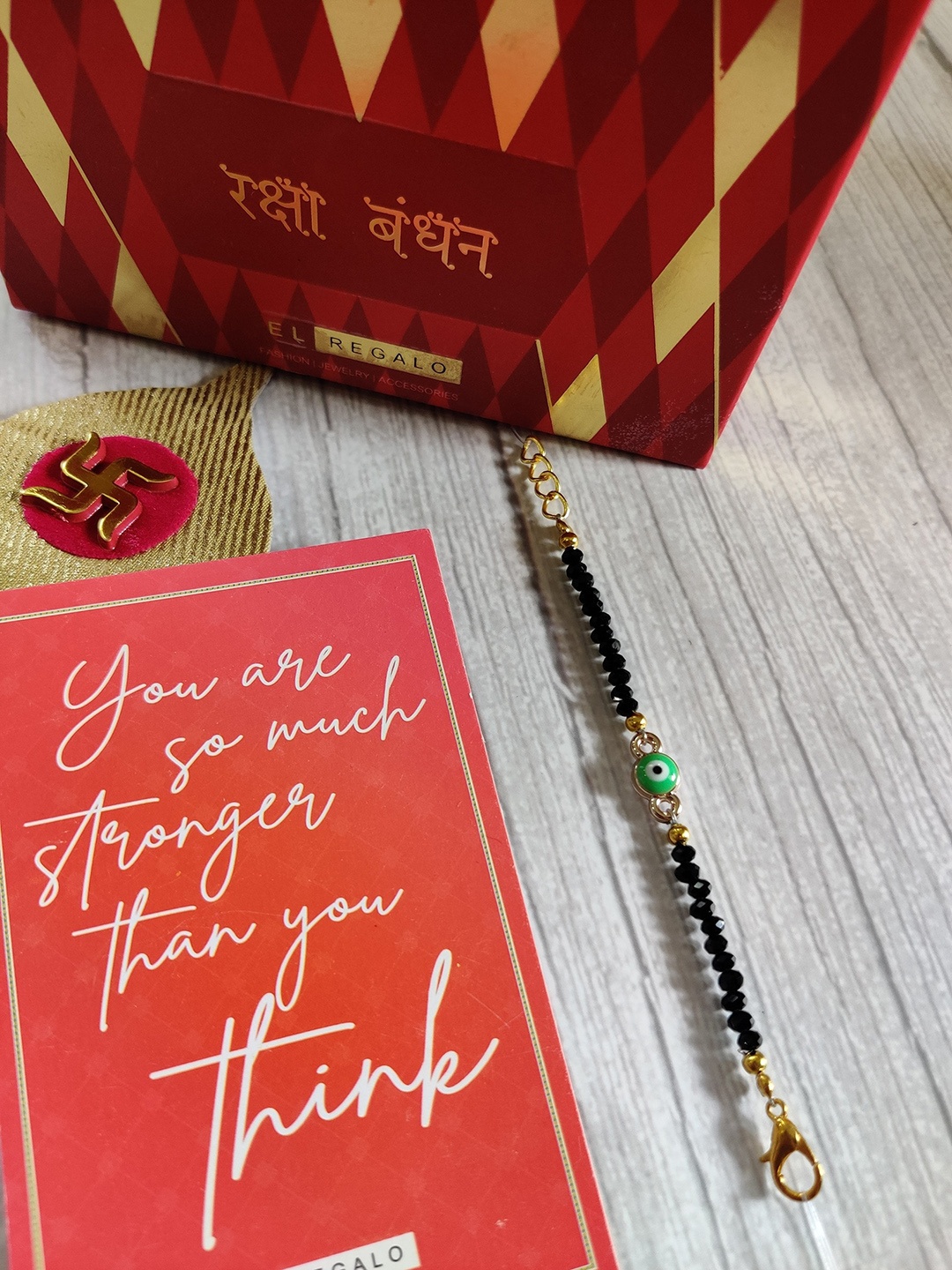 

EL REGALO Gold Coloured Evil Eye Rakhi Set For Baby, Green