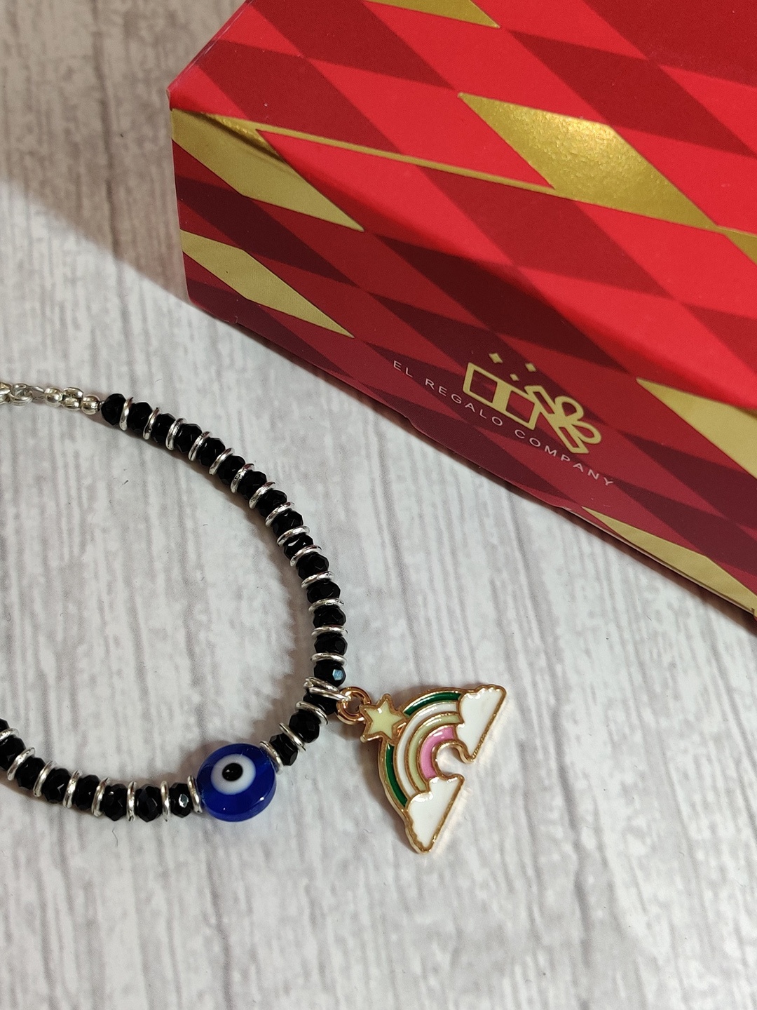 

EL REGALO Baby Silver Coloured Blue Evil Eye Rakhi With Greeting Card & Roli Chawal