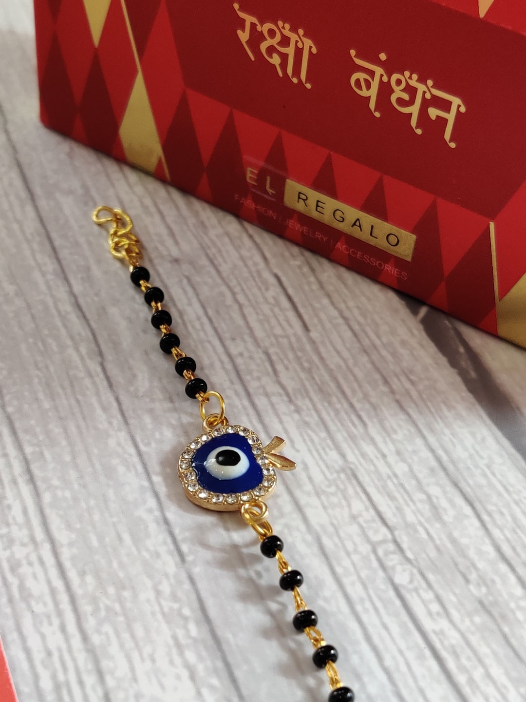 

EL REGALO Gold Blue Evil Eye Stone-Studded Nazaria Rakhi for Baby