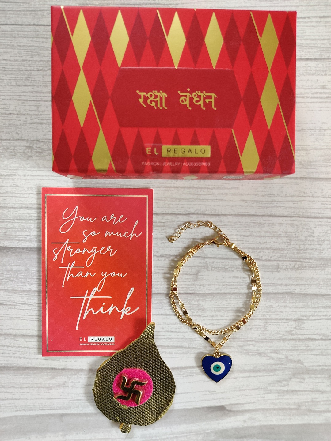 

EL REGALO Unisex Gold-Plated Blue Evil Eye Rakhi With Roli & Chawal