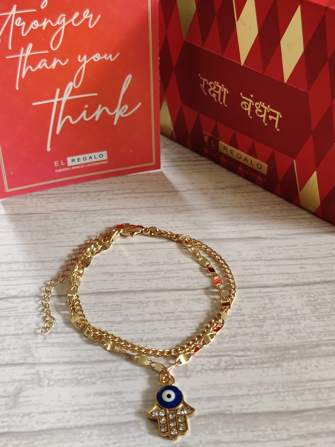 

EL REGALO Gold-Plated Evil Eye Rakhi With Greeting card & Roli Chawal