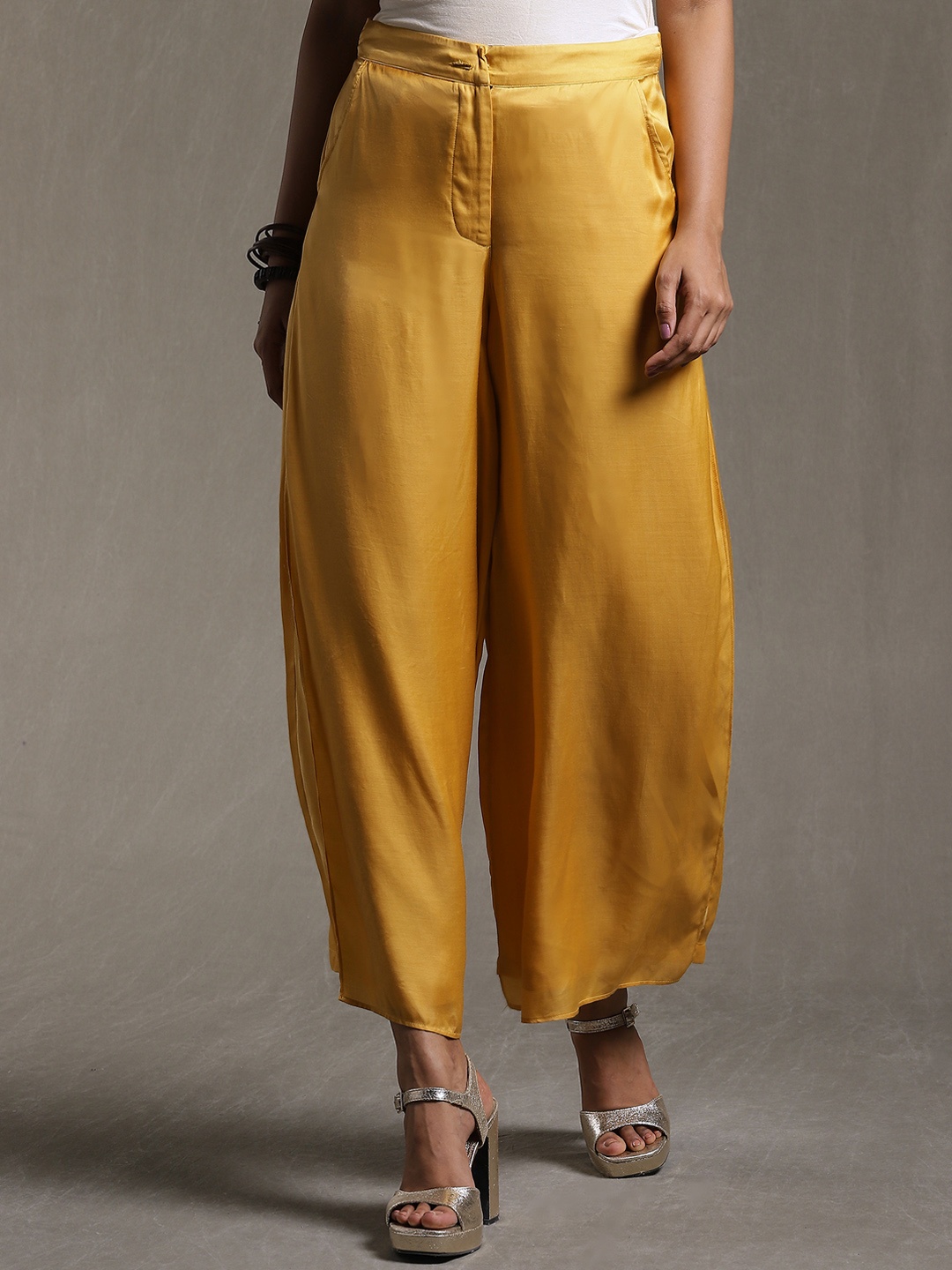 

Ritu Kumar Women Mustard Yellow Solid Satin Flared High-Rise Trousers