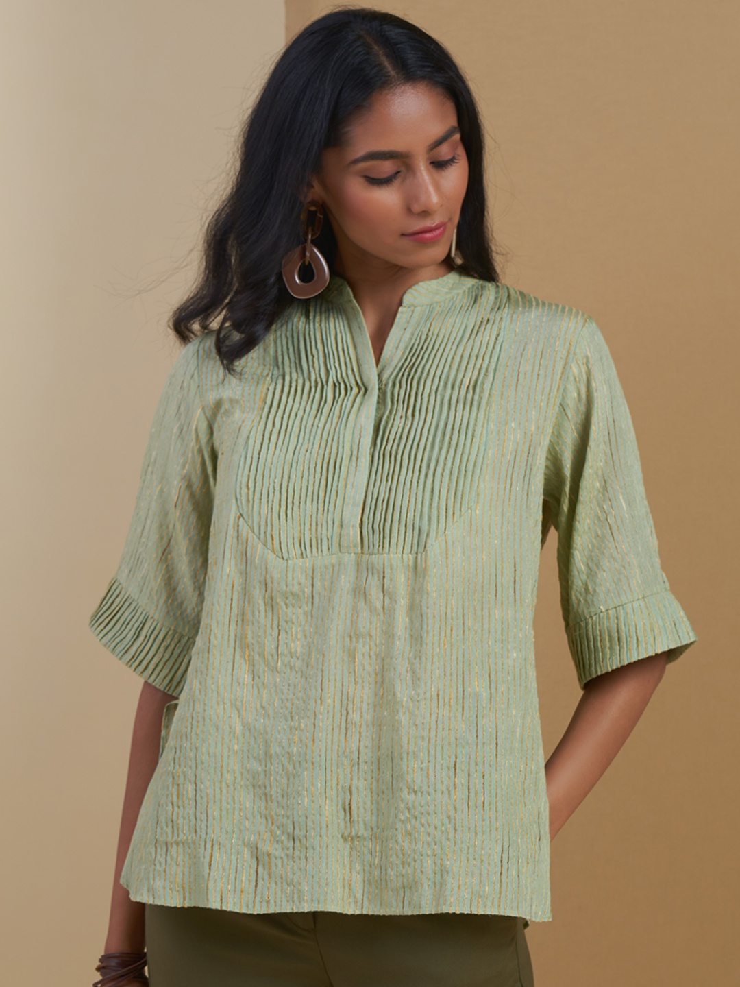 

Ritu Kumar Green & Golden Striped Flared Sleeves Pure Cotton Pleated Kurti
