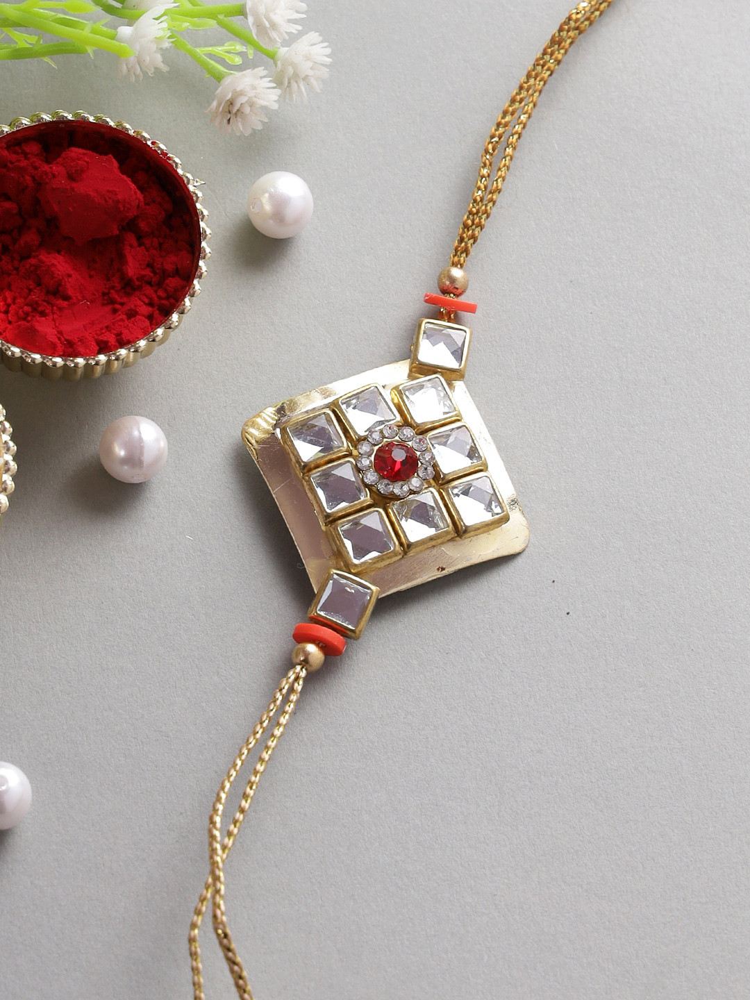 

Aapno Rajasthan Gold-Coloured & White Kundan Studded Thread Rakhi With Roli Chawal & Raksha Bandhan Greeting Card