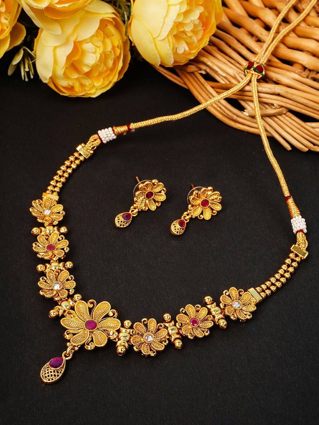 

Urmika Gold-Toned Magenta Stone Studded Jewellery Set