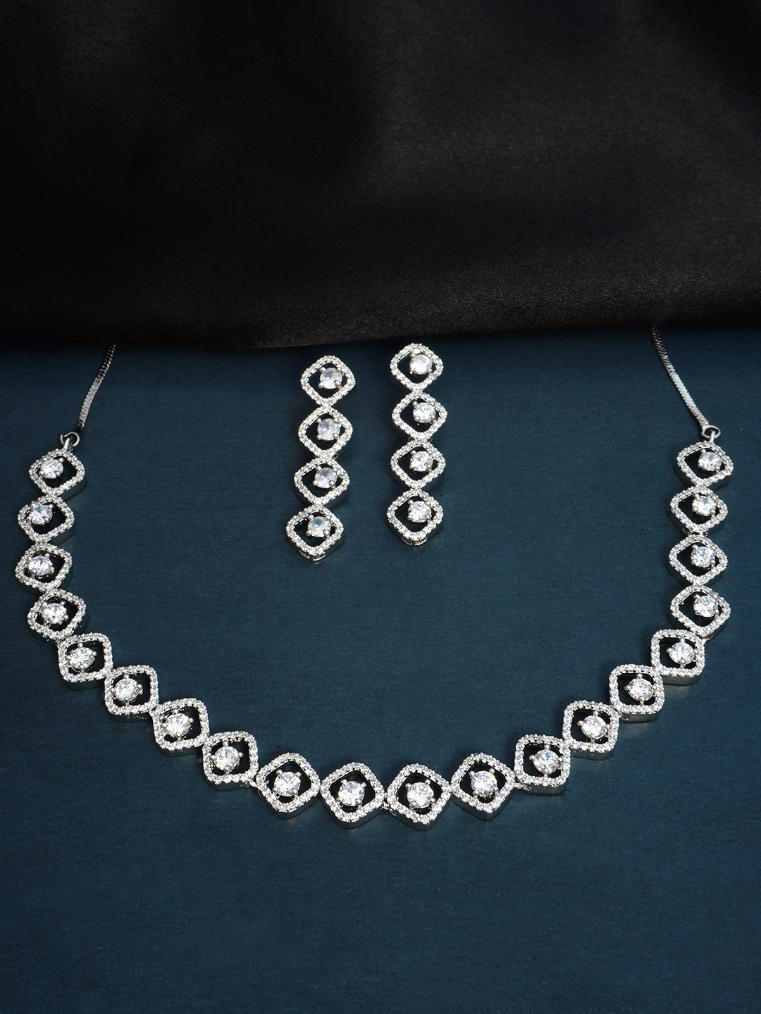 

Urmika Silver-Toned White AD Studded Jewellery Set