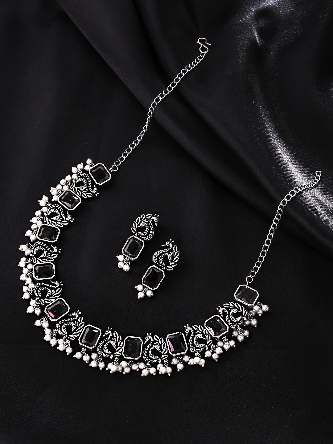

Yellow Chimes Silver-Plated Oxidized Black Peacock Designed Jewellery Set
