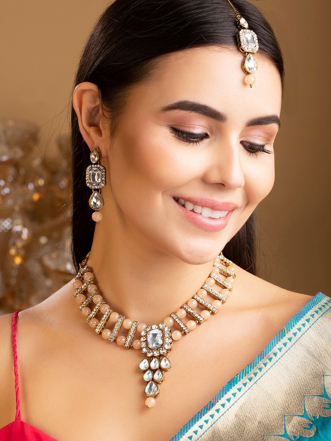 

Rubans Gold-Plated White & Peach-Coloured Kundan-Studded & Pearl Beaded Jewellery Set