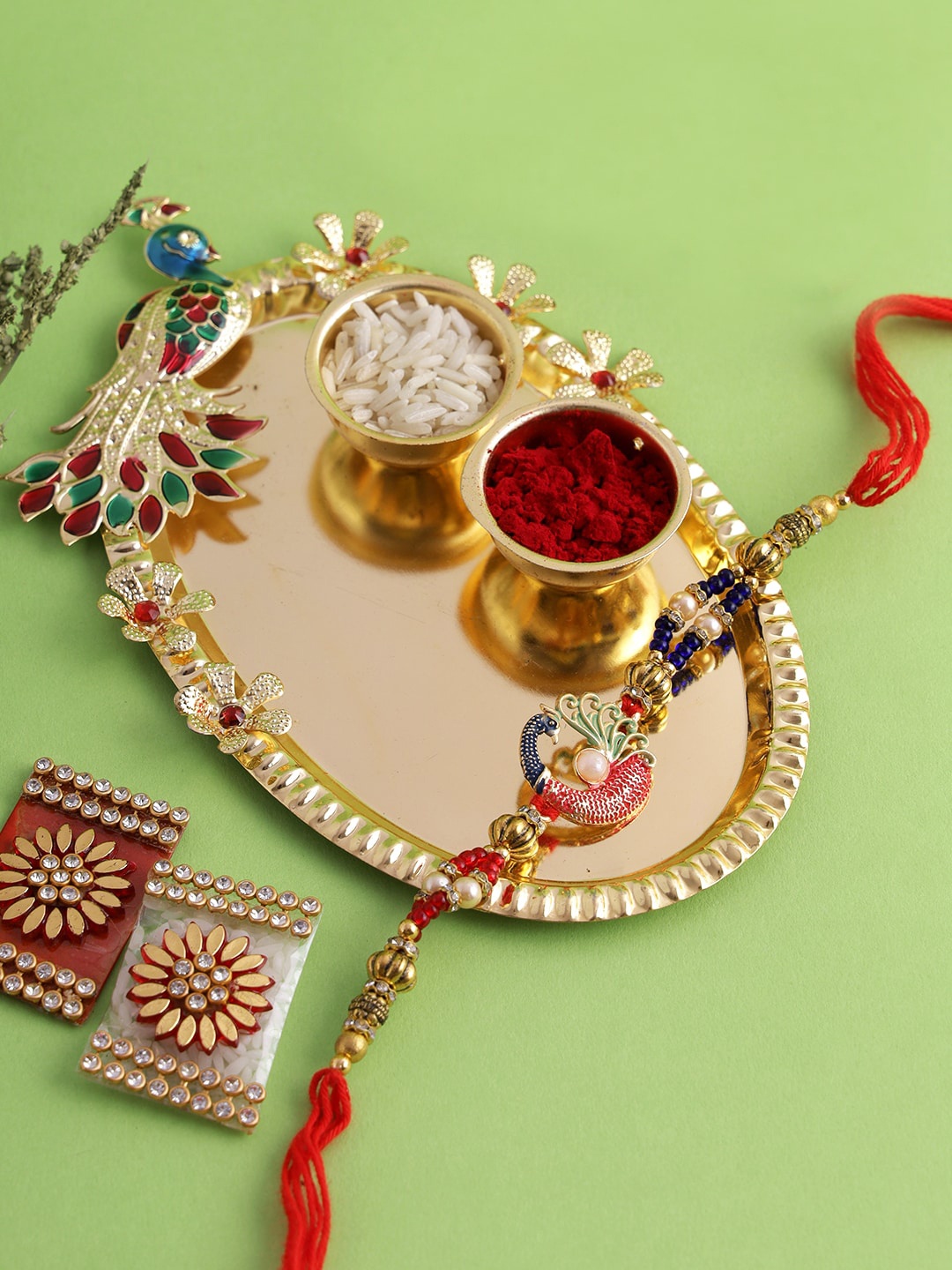 

Aapno Rajasthan Gold-Toned Handcrafted Pooja Thali & Peacock Rakhi