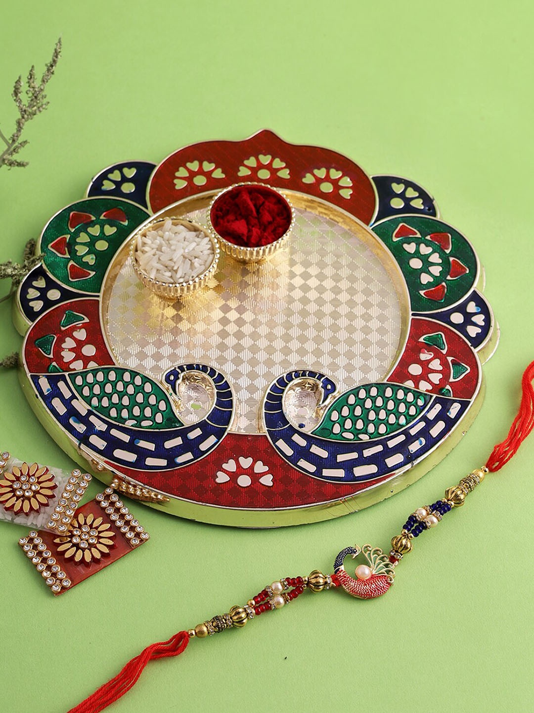 

Aapno Rajasthan Blue & Red Peacock Kumkum Chawal Thali Rakhi Set