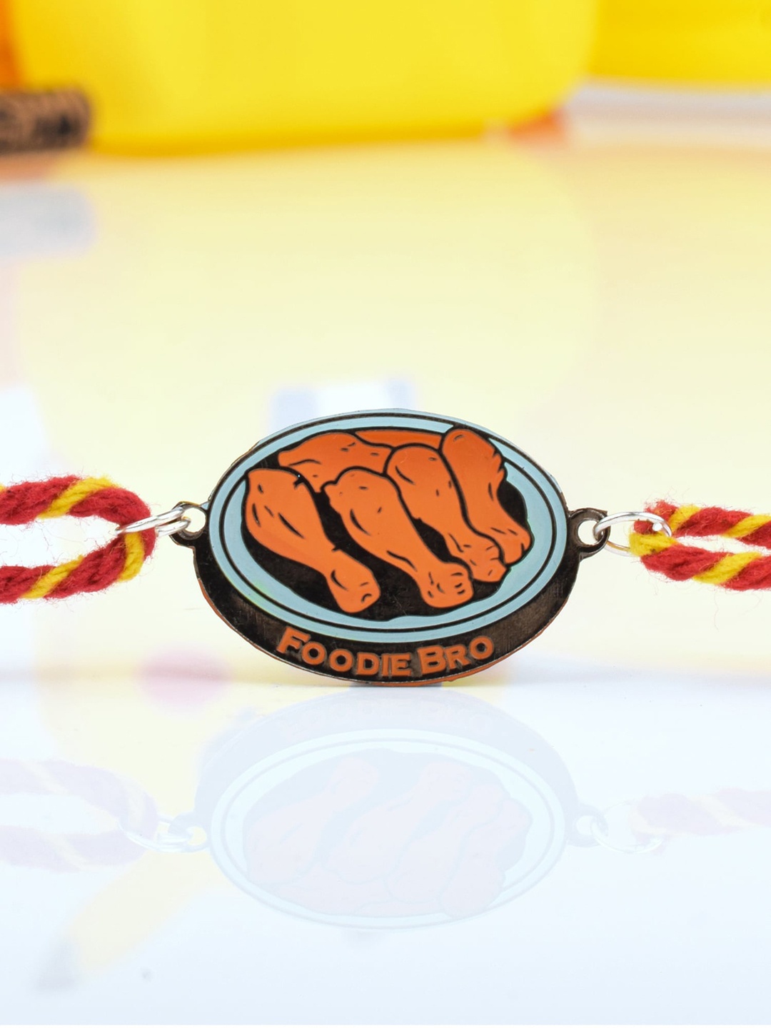 

Bigsmall Unisex Orange Colored Threaded & Foodie Bro Metallic Rakhi