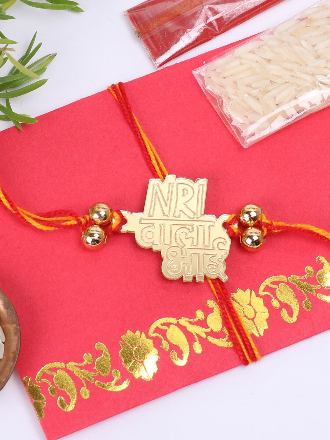 

The Magic Wand Gold-Toned & Red Thread Rakhi With Roli-Chawal