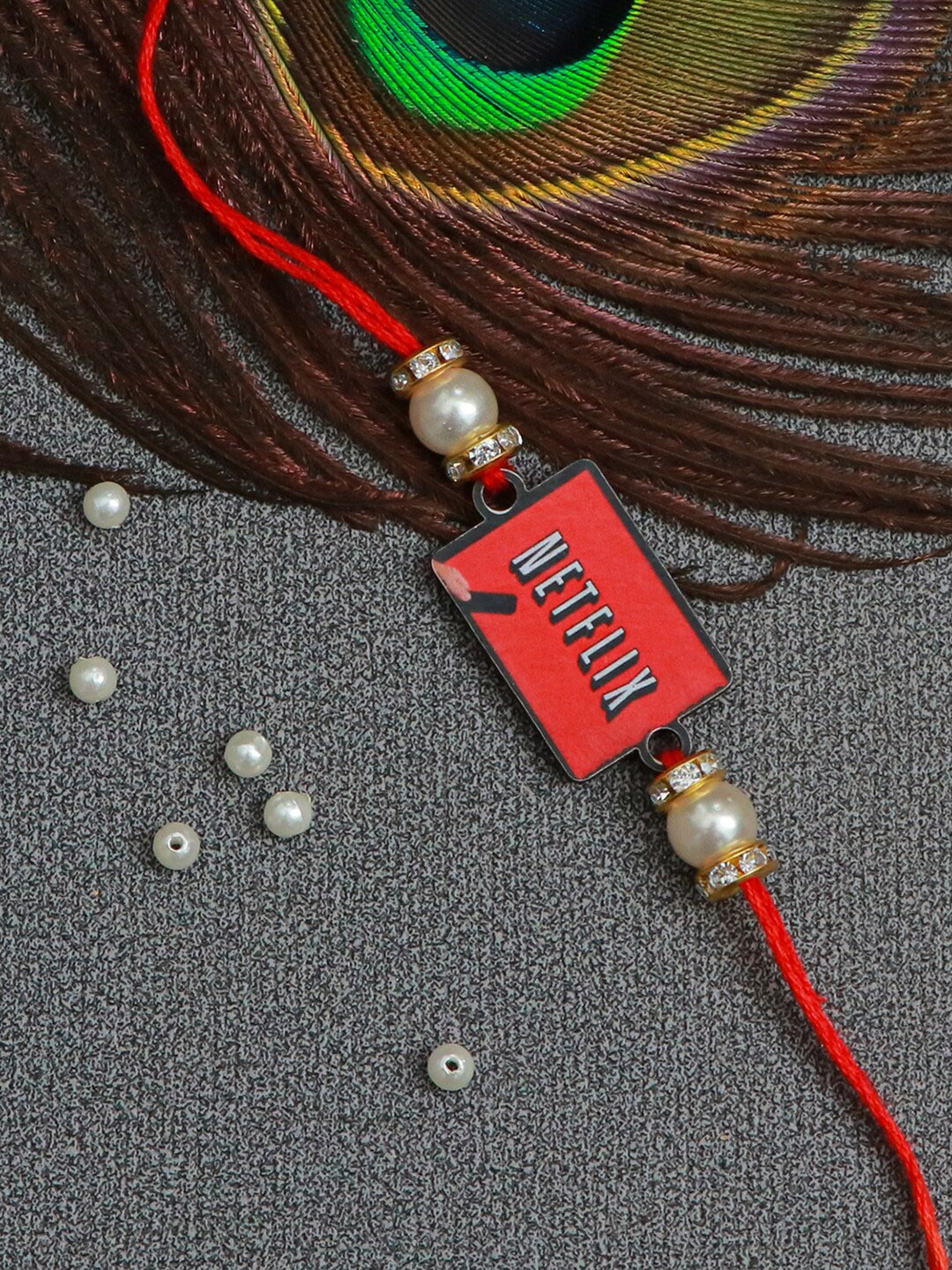 

The Magic Wand Red Pearl Beaded Thread Rakhi