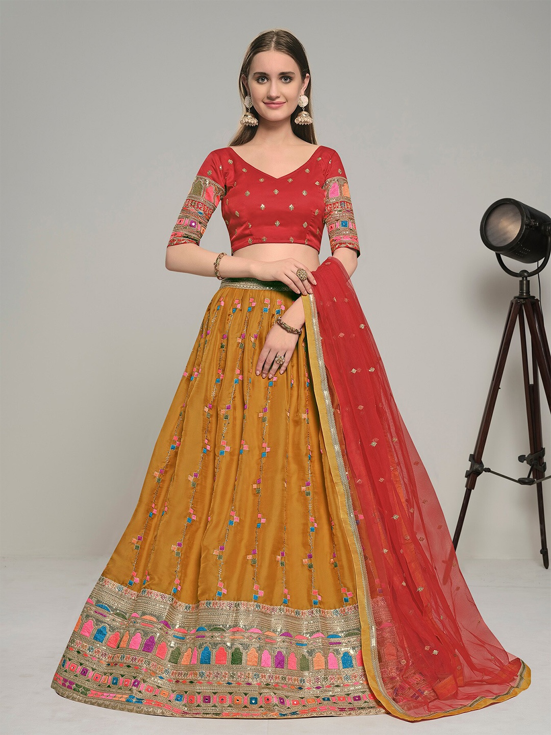 

DRESSTIVE Mustard & Red Embroidered Thread Work Semi-Stitched Lehenga & Unstitched Blouse With Dupatta