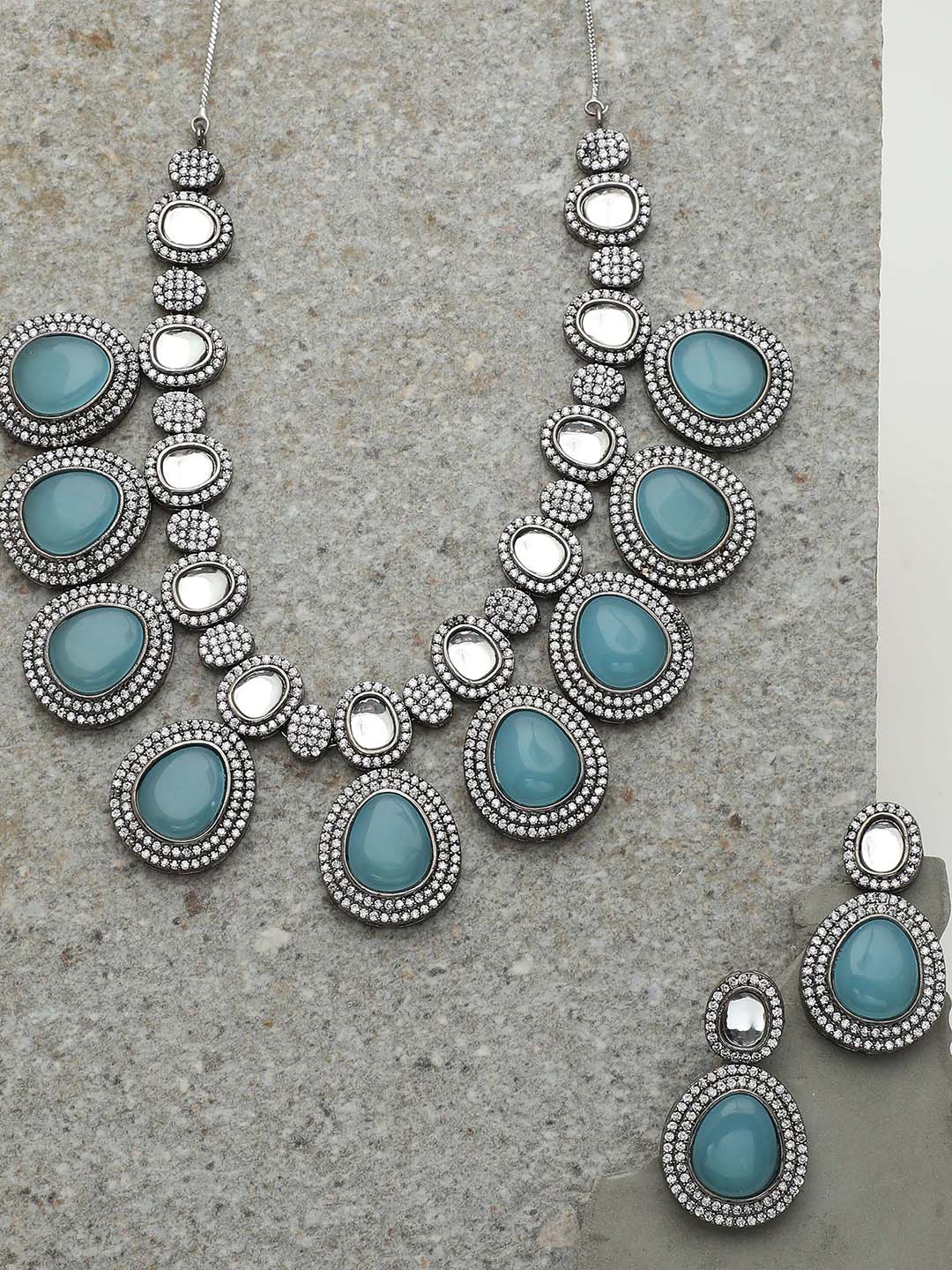 

SOHI Women Blue Silver Plated American Diamond and Designer Stone Necklace and Earring Set