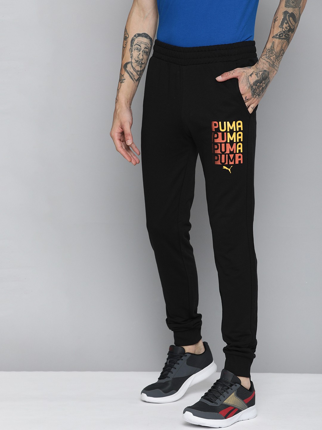 

PUMA Men Brand Logo Printed Mid-Rise Slim Fit Graphic Regular Joggers, Black