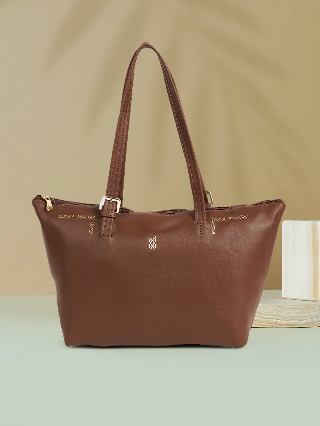 

Baggit Brown Solid Regular Structured Shoulder Bag with Minimal Embroidered Detail