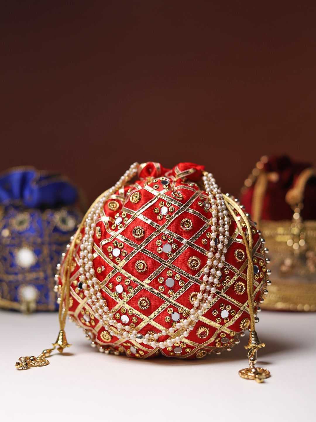 

LIKAA Red And Gold Toned Stones And Mirror Embellished Potli Clutch