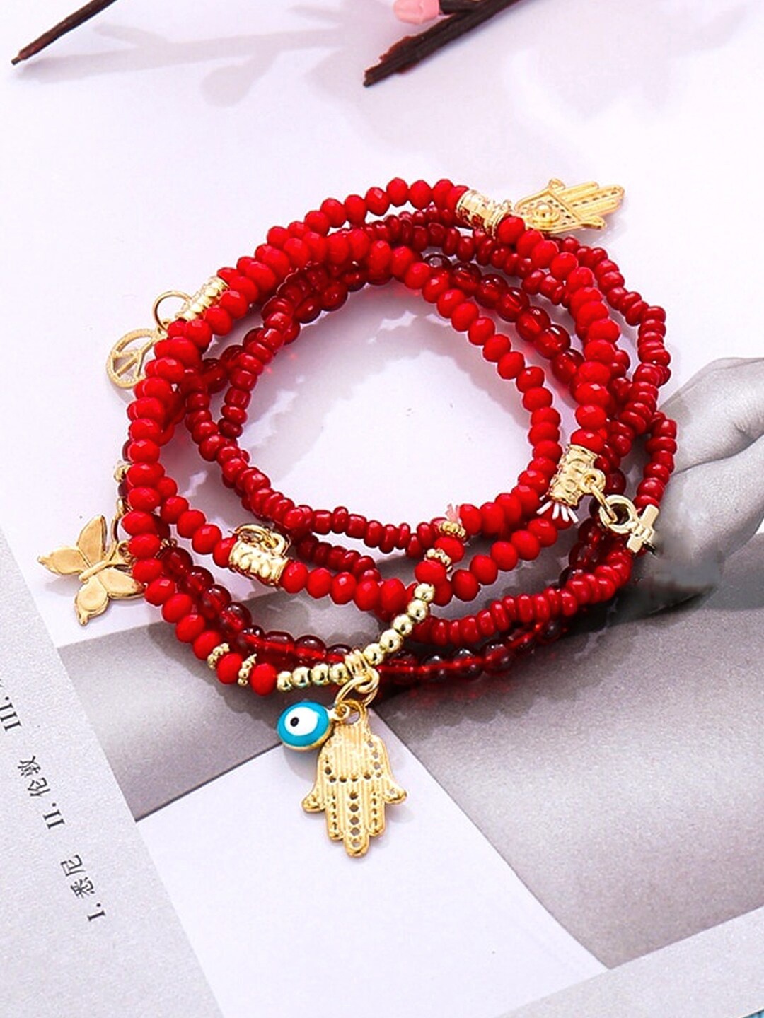 

Unwind by Yellow Chimes Women Red Multi Charmed Beaded Bracelet
