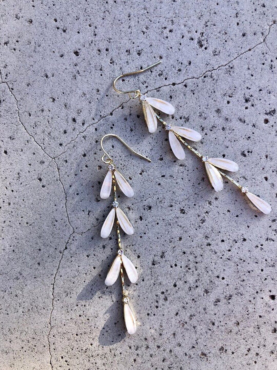 

Yellow Chimes Gold Toned Leaf Layered Pearl Drop Danglers Earrings, White