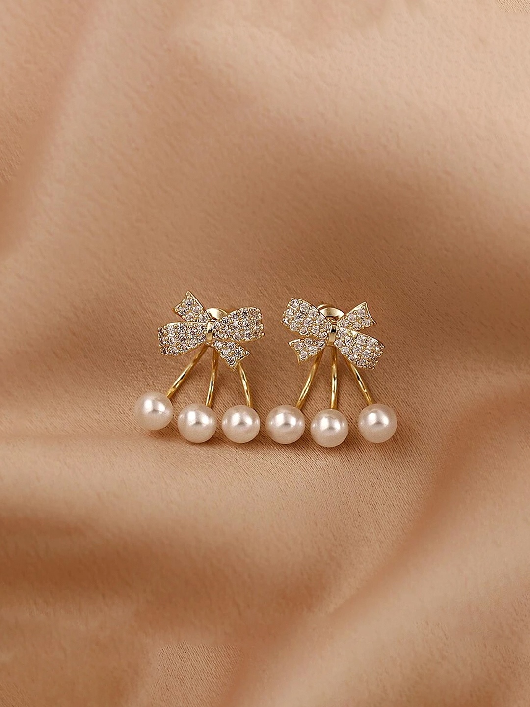 

Yellow Chimes Gold-Toned Crystal Studded Bow Shaped Stud Pearl Drop Earrings