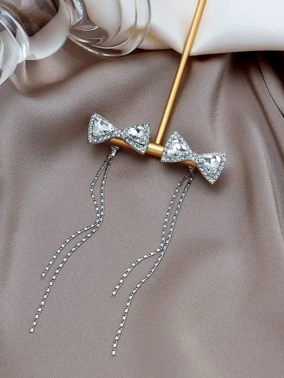 

Yellow Chimes Silver-Toned Crystal Studded Bow With Chain Dangler Earrings