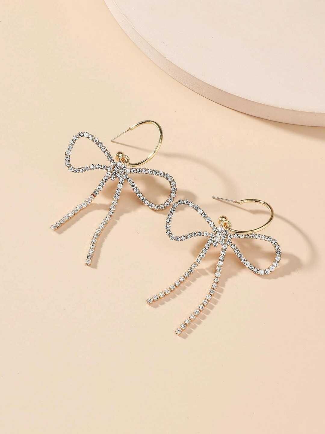 

Unwind by Yellow Chimes Gold Toned Crystal Studded Ribbon Designed Hoop Earrings