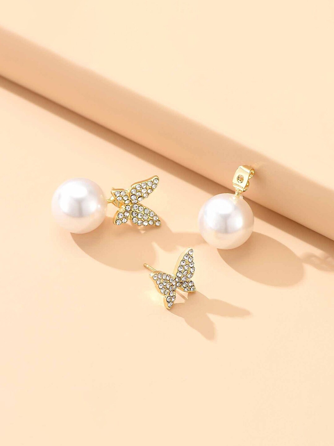 

Yellow Chimes Gold-Plated & White Butterfly Shaped Crystal Studded Pearl Drop Earrings