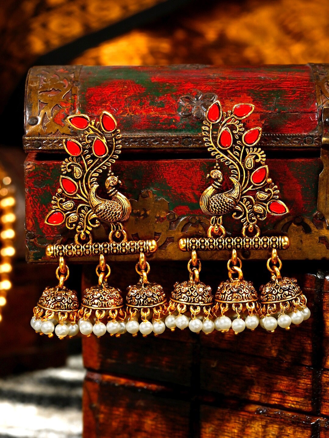 

Yellow Chimes Gold-Toned Oxidised Pink Crystal Studded Peacock Designed Jhumka Earrings