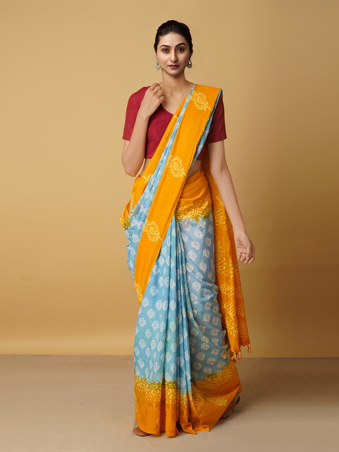 

Unnati Women Silks Blue & Orange Ethnic Motifs Zari Silk Blend Baluchari Saree