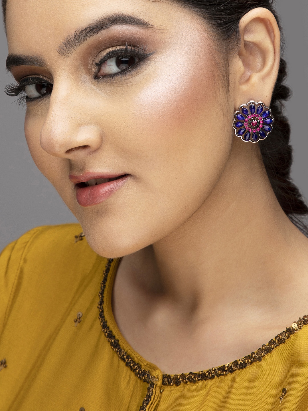 

Rubans Silver-Toned & Blue Stone Studded Floral Studs Earrings